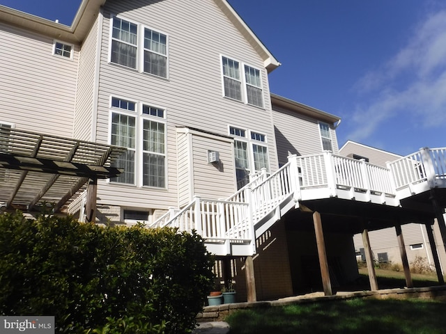 back of property with a wooden deck