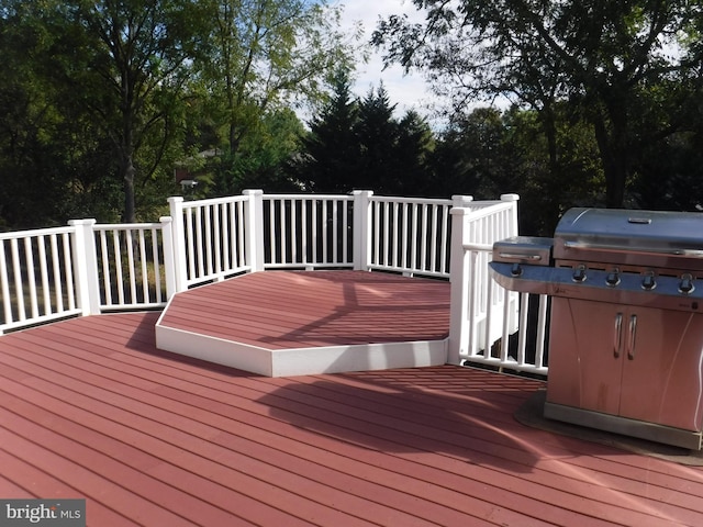 wooden terrace featuring a grill