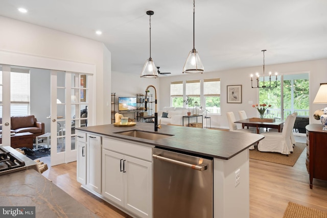 kitchen with a center island with sink, stainless steel dishwasher, light hardwood / wood-style floors, hanging light fixtures, and white cabinets