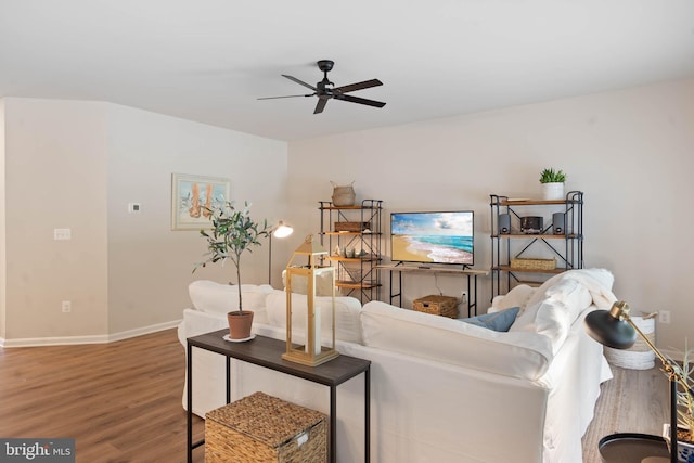 living room featuring ceiling fan and hardwood / wood-style flooring