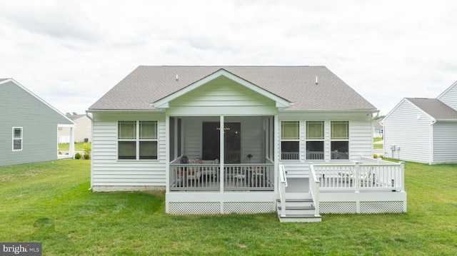 back of property featuring a lawn and a deck