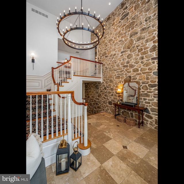 stairs with an inviting chandelier