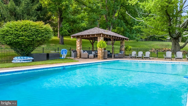 view of pool featuring an outdoor living space, a gazebo, and a lawn