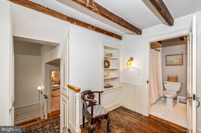 hall featuring dark hardwood / wood-style flooring and built in features