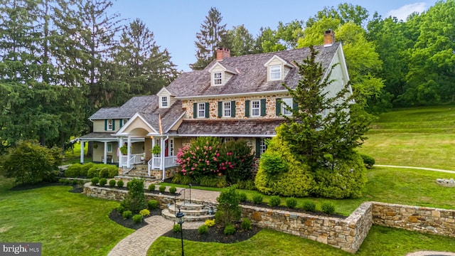 view of front of property with covered porch and a front lawn