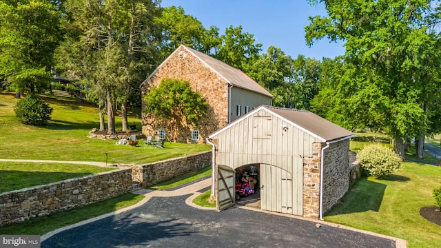 view of outbuilding featuring a lawn