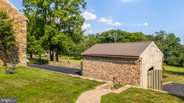 view of outbuilding featuring a yard