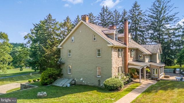 view of property exterior with a lawn