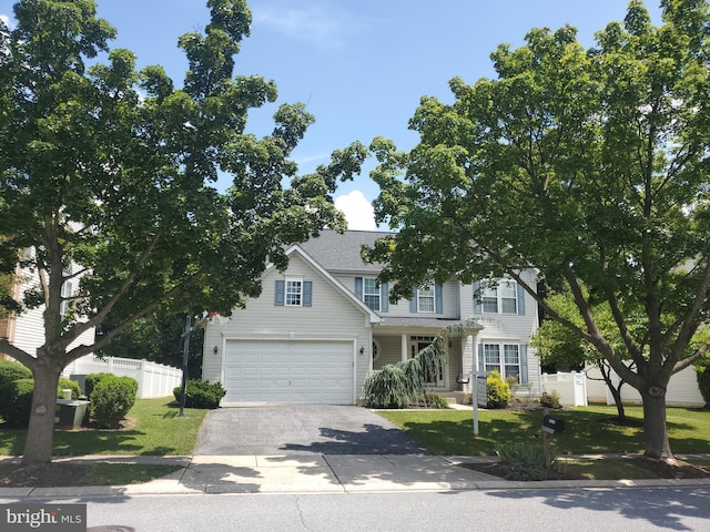 view of front facade with a front yard and a garage