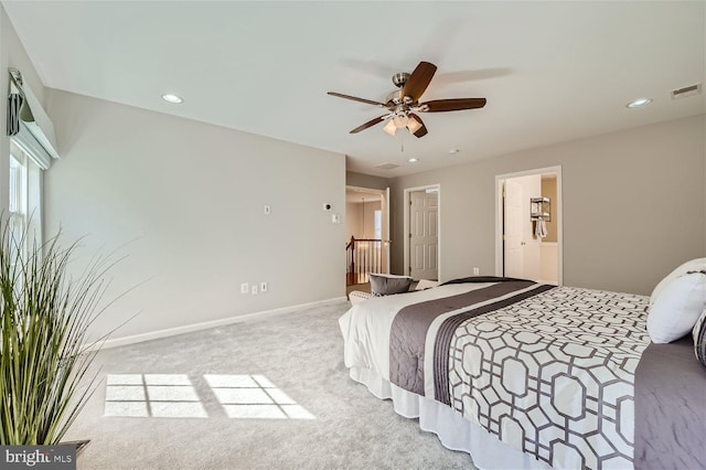 bedroom featuring ceiling fan, light carpet, and connected bathroom