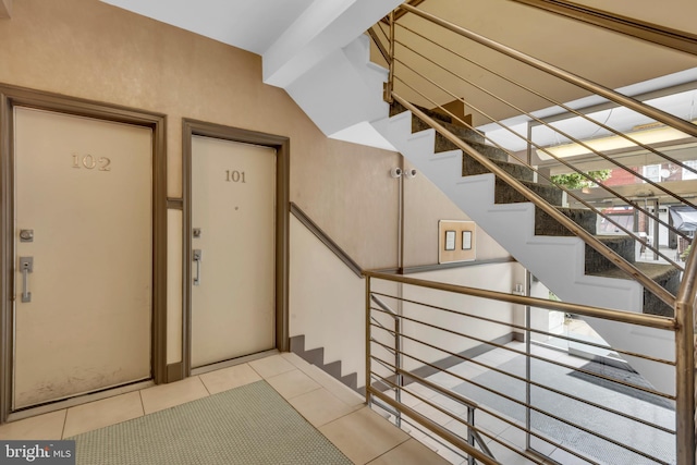 staircase with tile patterned floors