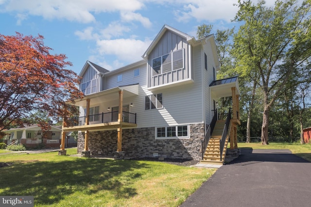 exterior space with a balcony and a yard