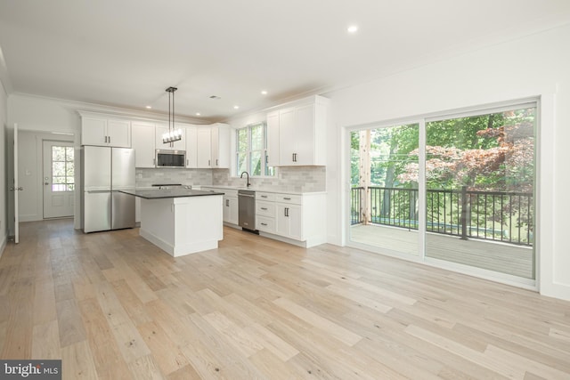 kitchen with white cabinetry, pendant lighting, appliances with stainless steel finishes, and a center island