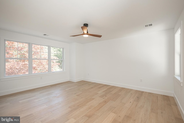 unfurnished room with ceiling fan and light wood-type flooring