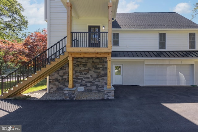 rear view of house with a garage