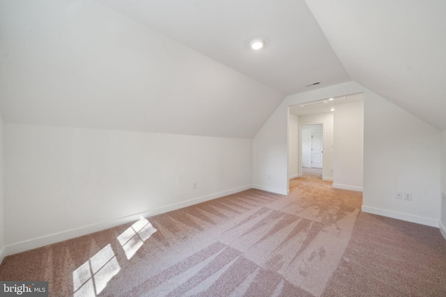 additional living space with light colored carpet and lofted ceiling