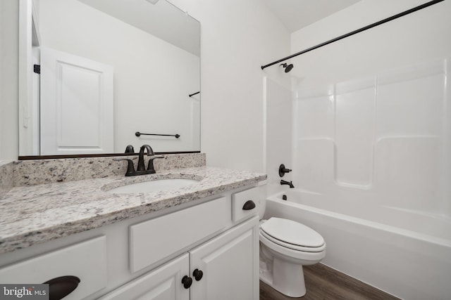 full bathroom featuring hardwood / wood-style floors, vanity, shower / bathtub combination, and toilet