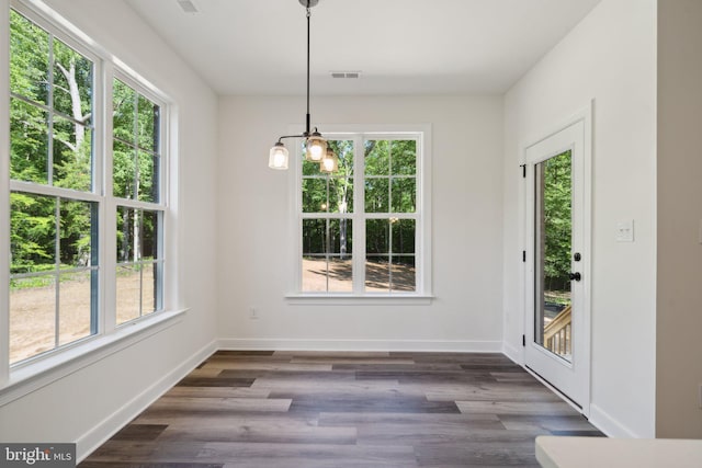 unfurnished dining area with dark hardwood / wood-style flooring