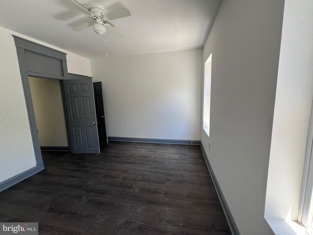 unfurnished room featuring ceiling fan and dark hardwood / wood-style flooring