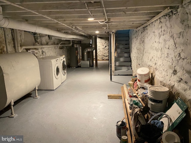 basement featuring washer and clothes dryer and water heater