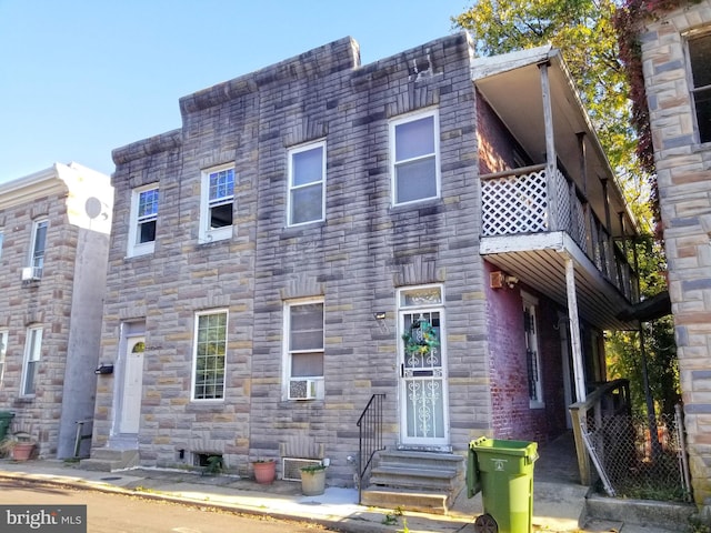 view of property with a balcony and cooling unit