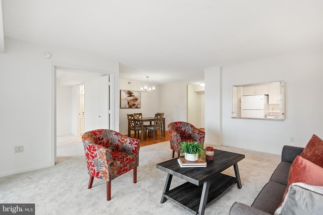 living room featuring a chandelier, light carpet, and baseboards