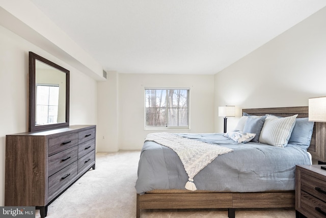 bedroom featuring light carpet, multiple windows, and visible vents