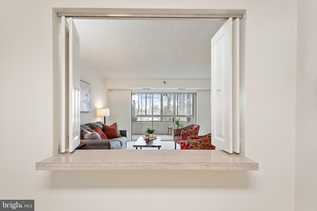 living area featuring a textured ceiling