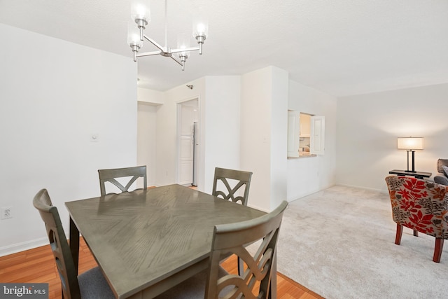 dining space featuring a notable chandelier and baseboards