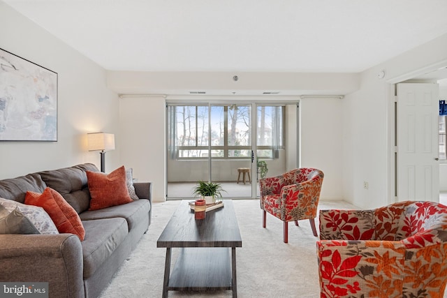 living room featuring light carpet and visible vents