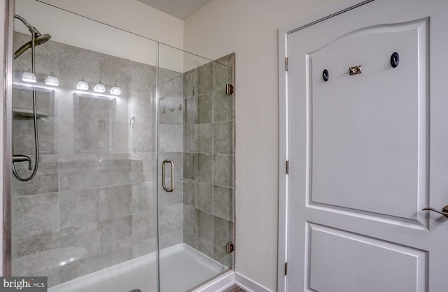 bathroom with a shower with door