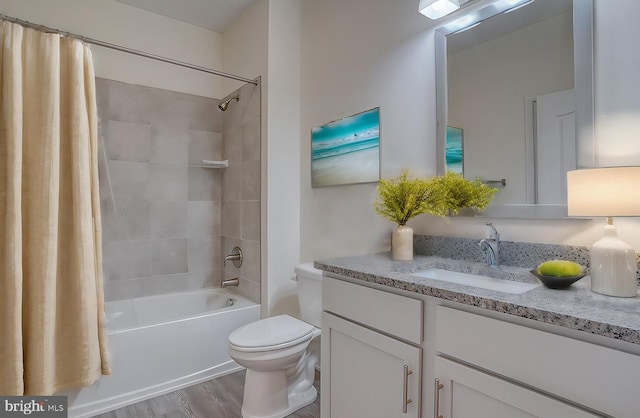 full bathroom with hardwood / wood-style floors, shower / tub combo, toilet, and vanity