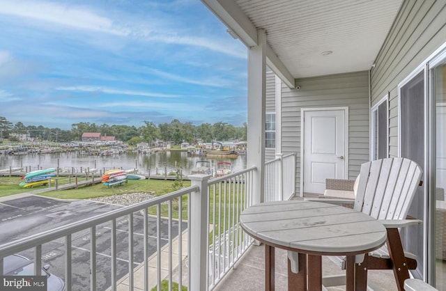 balcony with a water view and a boat dock