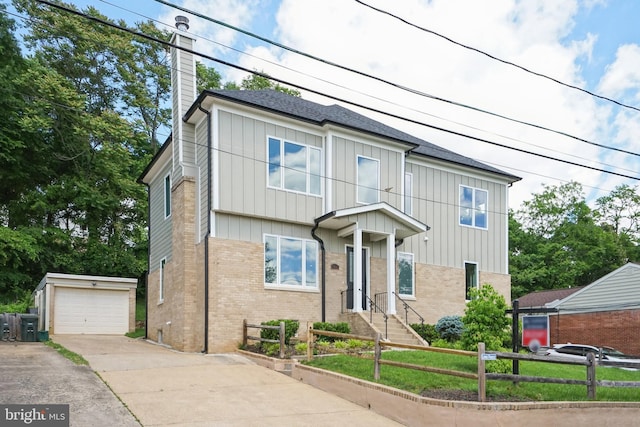 view of front facade featuring a garage and an outdoor structure