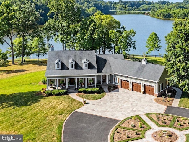 cape cod-style house with a garage, a water view, a front yard, and covered porch