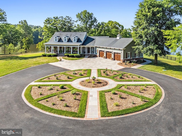 view of front facade with a garage, a porch, and a front lawn