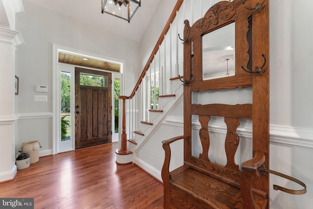 foyer with lofted ceiling and hardwood / wood-style floors