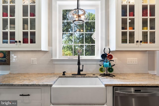 kitchen with white cabinetry, dishwasher, sink, and hanging light fixtures