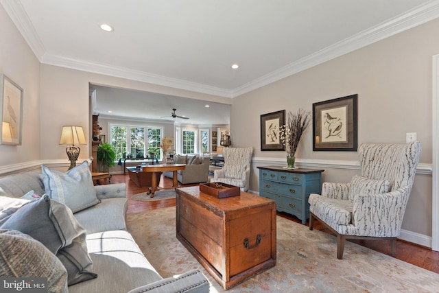 living room featuring crown molding and light hardwood / wood-style floors