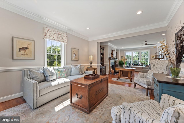 living room with ornamental molding and light hardwood / wood-style floors