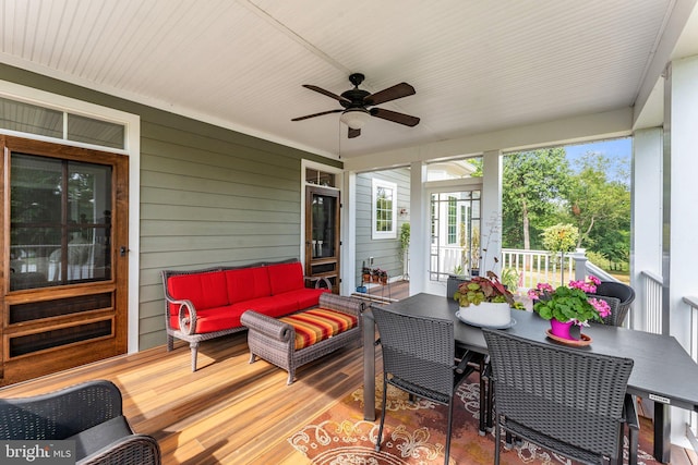 sunroom / solarium featuring ceiling fan