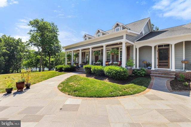 exterior space featuring a front lawn and a porch