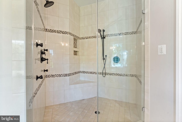 bathroom featuring a shower with door