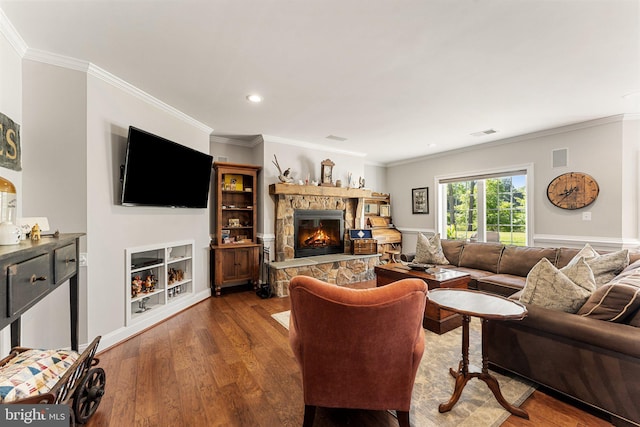 living room featuring crown molding, a fireplace, and wood-type flooring