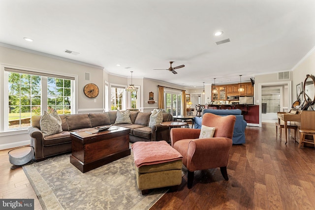 living room featuring crown molding, wood-type flooring, and plenty of natural light