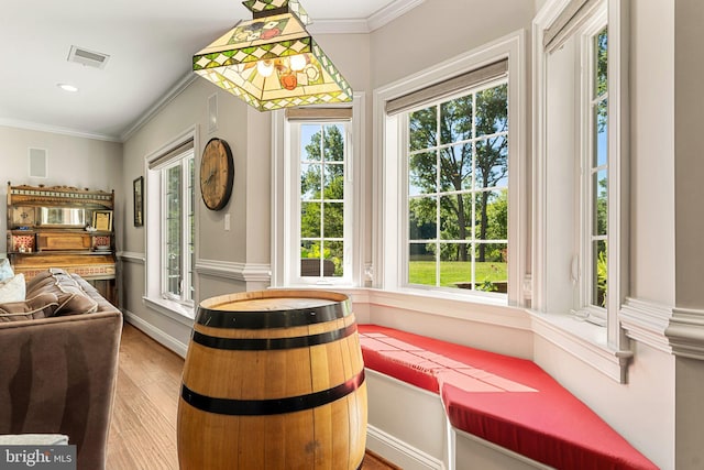 interior space with hardwood / wood-style floors and crown molding