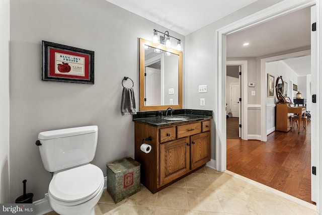 bathroom with tile patterned floors, vanity, and toilet