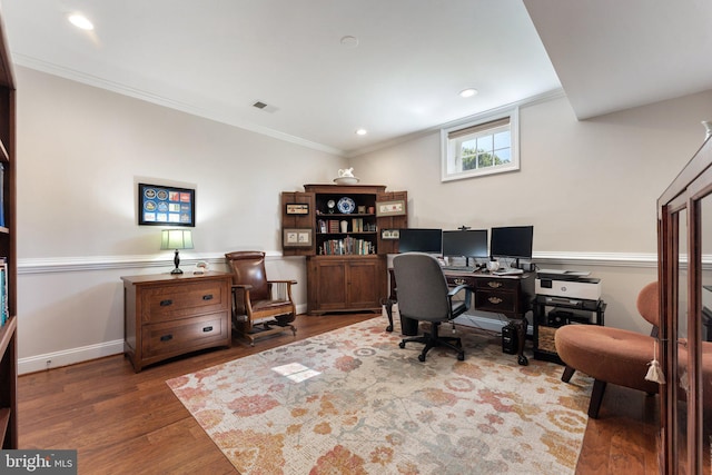 home office with dark hardwood / wood-style flooring and ornamental molding