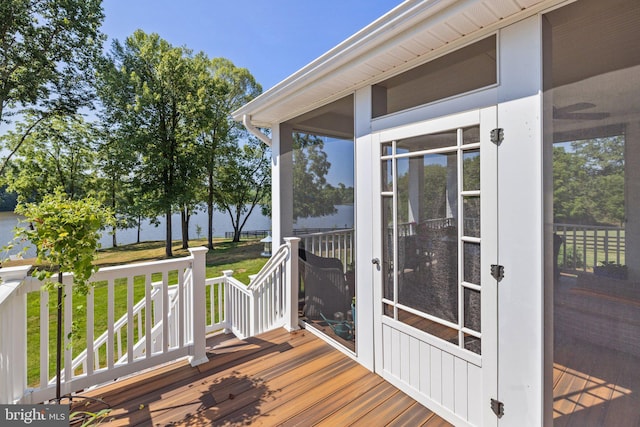 wooden deck featuring a lawn