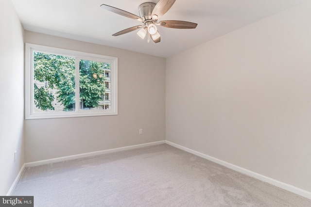 empty room with ceiling fan and light colored carpet